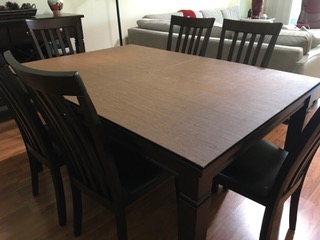 Custom Dark Oak table pad on a rectangular dining table.